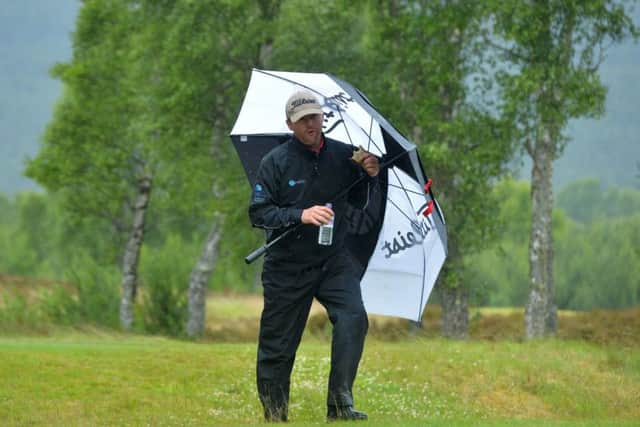 Battling the elements in Aviemore, Michael Hoey grabs a sandwich during his opening-round 68. Picture: Getty.