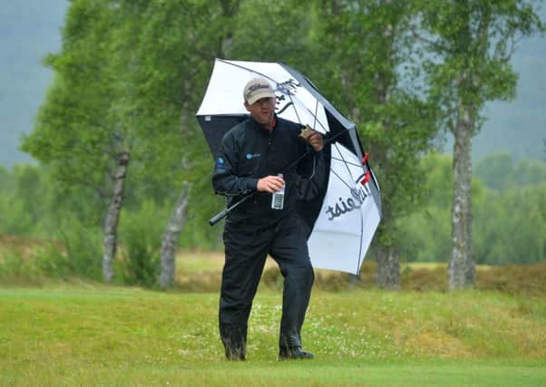 Battling the elements in Aviemore, Michael Hoey grabs a sandwich during his opening-round 68. Picture: Getty.