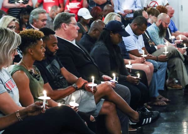 Little Rock mayor Mark Stodola, fourth from left, at a candlelit vigil for victims of the shootings. Picture: AP