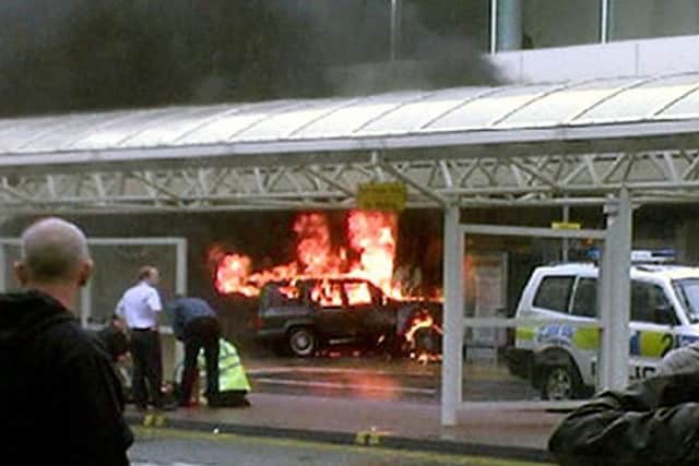 Flames rise from a jeep after the terrorist car bomb attack on Glasgow Airport in 2007. Picture: PA