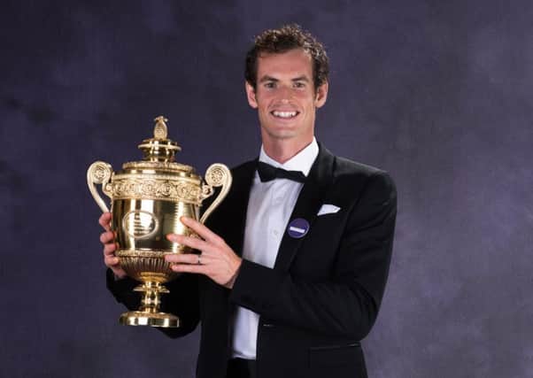 Andy Murray poses with the Wimbledon trophy after winning the title last year. Picture: Getty