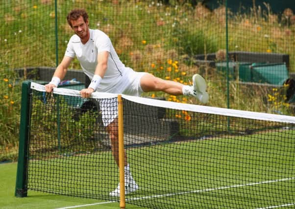 Andy Murray does his warm-up exercises before beginning yesterdays practice session. Picture: Getty.