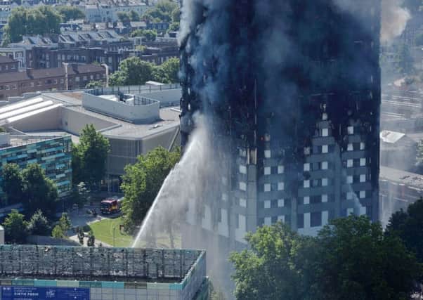 Smoke billows from a fire that has engulfed the 24-storey Grenfell Tower in west London.  Picture:Victoria Jones/PA Wire