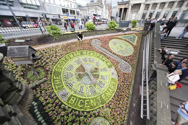 Gargeners at work finishing the floral clock in Princes St. for the Scotsman bicentenary