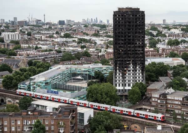 A tube train passes the burnt-out shell of Grenfell Tower in Kensington, west London. Picture: Getty