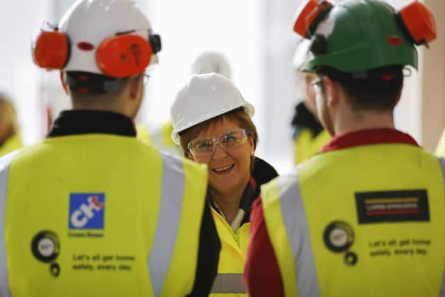 Nicola Sturgeon talks to construction workers on a site in Dumfries