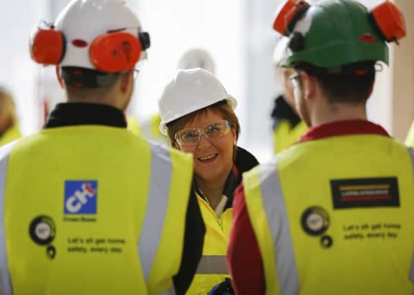 Nicola Sturgeon talks to construction workers on a site in Dumfries