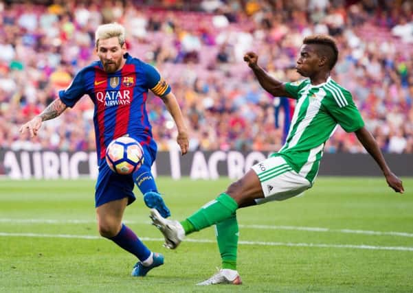 Charly Musonda (right) attempts to evade the attentions of Lionel Messi in a match between Real Betis and Barcelona. Picture: Getty Images
