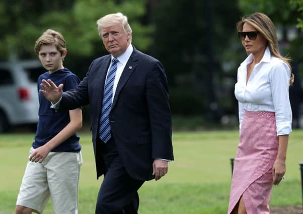Donald Trump, centre, with son Barron (left) and First Lady Melania Trump, on the White House's South Lawn. Picture: Getty Images
