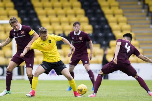 01/07/17 PRE SEASON FRIENDLY 
 LIVINGSTON V HEARTS 
 TONI MACARONI ARENA - LIVINGSTON
 Livingston debut Joshua Peters (C) in action against Hearts debut Christophe Berra (L)