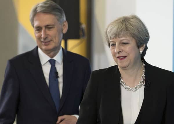 Philip Hammond and Theresa May are being urged to ease austerity measures and end the public sector wage cap. Picture: Getty