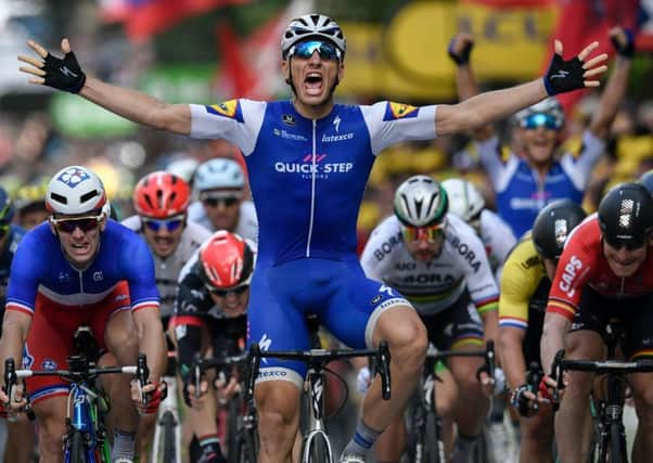 Germany's Marcel Kittel celebrates as he crosses the finish line in Liege ahead of Arnaud Demare, left, and Andre Greipel, right. Picture: AFP/Getty Images