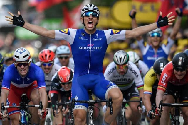 Germany's Marcel Kittel celebrates as he crosses the finish line in Liege ahead of Arnaud Demare, left, and Andre Greipel, right. Picture: AFP/Getty Images