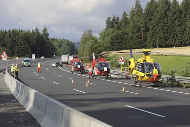 Rescue helicopters sit on the motorway A9 near Muenchberg, Picture; AP