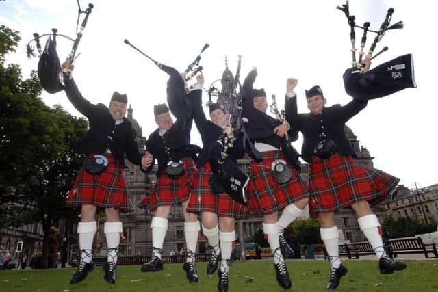 Members of current champions, Field Marshal Montgomery Pipe Band, pictured in George Square. Picture: Robert Perry