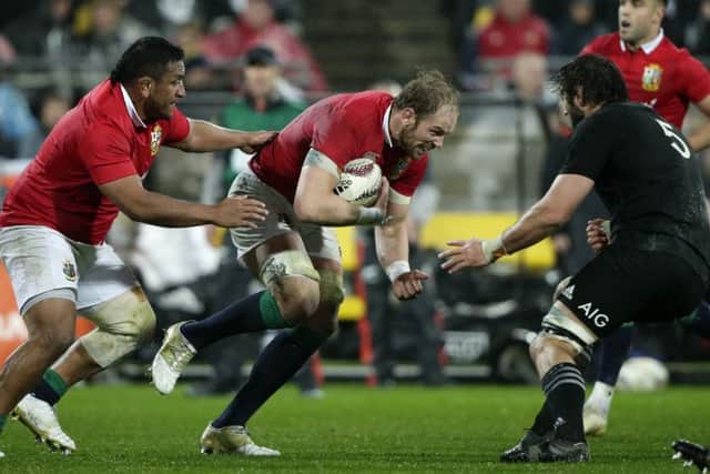 Alun Wyn Jones runs at New Zealand second row forward Sam Whitelock during Saturday's second Test in Wellington. Picture: Mark Baker/AP