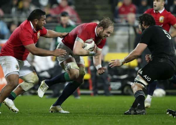 Alun Wyn Jones runs at New Zealand second row forward Sam Whitelock during Saturday's second Test in Wellington. Picture: Mark Baker/AP