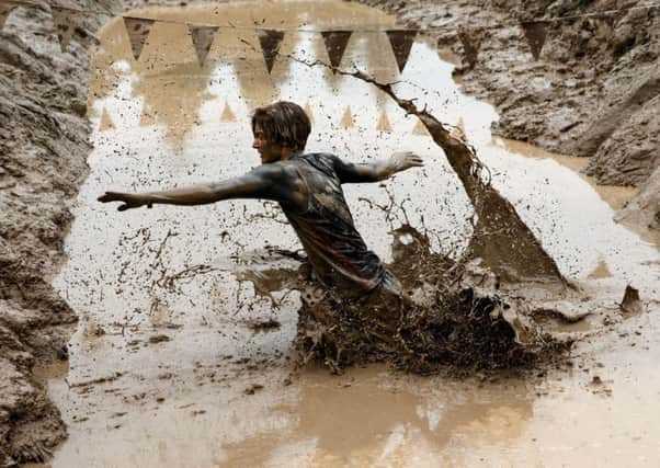 Participants take part in a Tough Mudder event race at Drumlanrig Castle, Thornhill in Scotland. NHS Dumfries and Galloway have linked the event to a small E.coli outbreak.