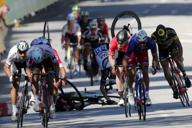Peter Sagan, far left, sprints as Mark Cavendish, centre, and fellow British rider Ben Swift crash in a dramatic finale to stage four. Picture: AP Photo/Christophe Ena