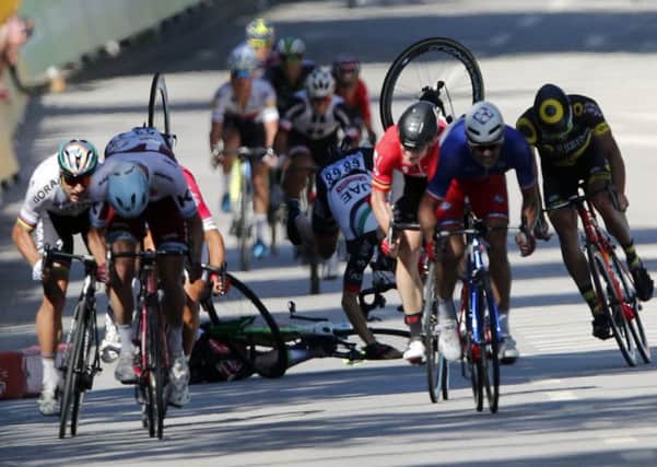 Peter Sagan, far left, sprints as Mark Cavendish, centre, and fellow British rider Ben Swift crash in a dramatic finale to stage four. Picture: AP Photo/Christophe Ena