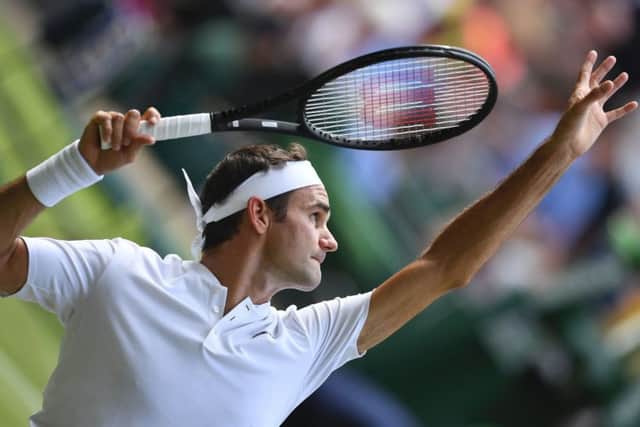 Roger Federer serves during his win against Alexandr Dolgopolov. It was his 85th victory at Wimbledon, moving him ahead of Jimmy Connors. Picture: AFP/Getty