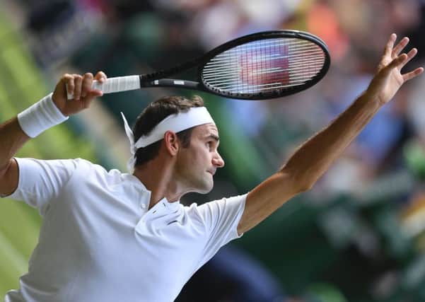 Roger Federer serves during his win against Alexandr Dolgopolov. It was his 85th victory at Wimbledon, moving him ahead of Jimmy Connors. Picture: AFP/Getty