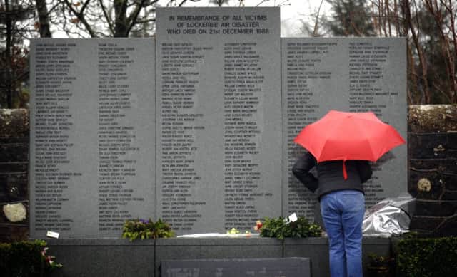 A woman visits the wall of names in the Lockerbie disaster memorial garden at Dryfesdale cemetery. The bombing killed 270 people. Picture: Jane Barlow/TSPL