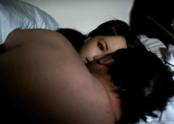 A man shares a bed with his silicone sex doll Saori (facing) at his apartment on the outskirts of Tokyo. Experts warn sex dolls will progress into sexbots.
 Picture: AFP/Getty Images