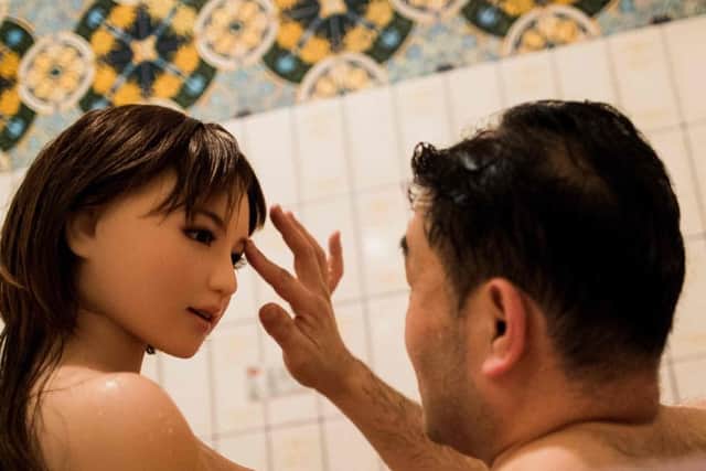 A man with his silicone sex doll Saori (facing) at his apartment on the outskirts of Tokyo. Experts warn sex dolls will progress into sexbots.
 Picture: AFP/Getty Images