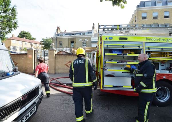 Firefighters seen outside the school in Hackney this morning. Picture: PA