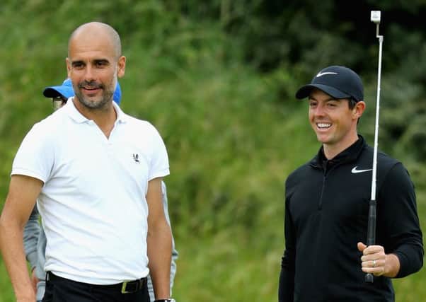Pep Guardiolla stands with Rory Mcilroy on the 8th green during the Pro-Am of the Dubai Duty Free Irish Open at Portstewart Golf Club.  Picture: Warren Little/Getty Images