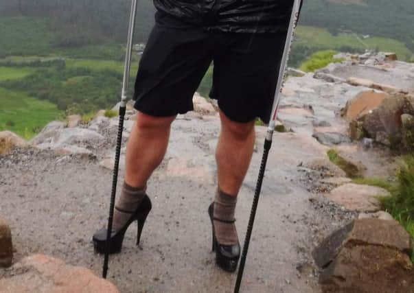 Ben Conway, a daring student who has ditched his hiking boots to climb up Britain's highest peak in a pair of five-inch heels. PA