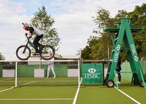 Danny MacAskill performs a daredevil ride, blocking Tim Henmans efforts to play tennis at Wimbledon. Picture: HSBC Sport