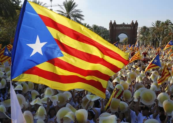Supporters wave pro-independence Catalan flags in Barcelona. Pic: PAU BARRENA/Getty Images