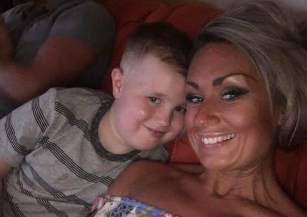 Luke Robertson, pictured with mum Jennifer, is receiving revolutionary treatment for his brain tumour in Mexico.
 Picture: Contributed