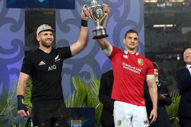New Zealand's Kieran Read and British and Irish Lions' Sam Warburton hold up the trophy after the drawn test series. Picture: MICHAEL BRADLEY/AFP/Getty Images