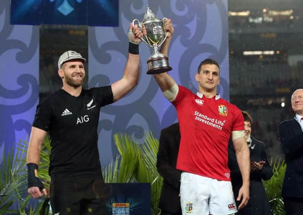 New Zealand's Kieran Read and British and Irish Lions' Sam Warburton hold up the trophy after the drawn test series. Picture: MICHAEL BRADLEY/AFP/Getty Images