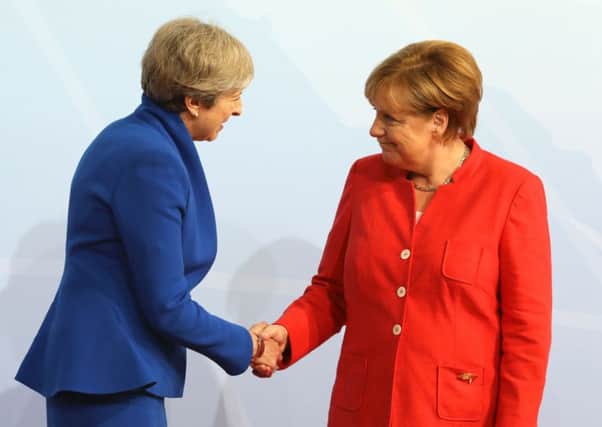 German Chancellor Angela Merkel greets Prime Minister Theresa May at the G20 in Hamburg. Picture: AFP/Getty Images