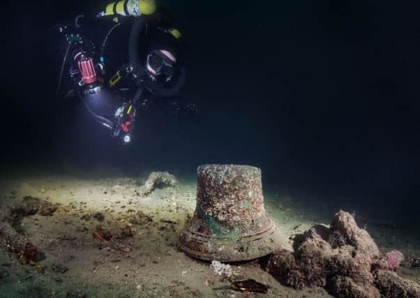 A diver looking at the bell on the wreck of the HMS Vanguard  in Scapa Flow. Picture: PA