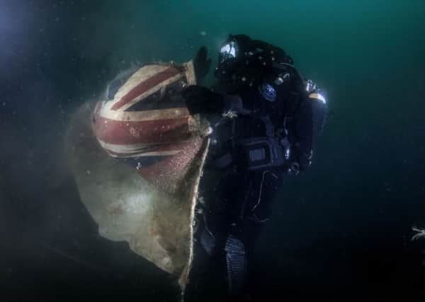 Royal Navy Northern Diving Group (NDG) recovering an old white ensign rom the wreck of the HMS Vanguard that was laid in 2009  in Scapa Flow. Picture: Marjo Tynkkynen/MS Vanguard Expedition/PA Wire