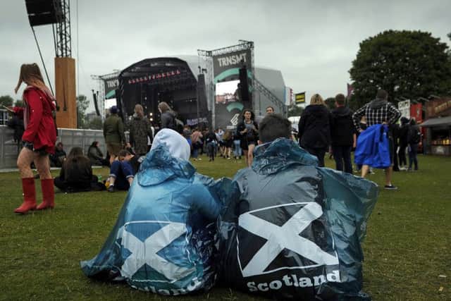 Festival-goers shelter from the rain on the third day of TRNSMT music. Picture: ANDY BUCHANAN/AFP/Getty Images