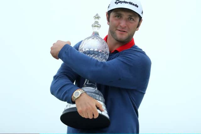 Jon Rahm hugs the Dubai Duty Free Irish Open after his six-shot success at Portstewart. Picture: Getty.