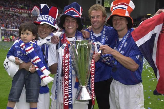 Arthur Numan along with (left to right) Michael Mols, Fernando Rickson and Bert Konterman and Arthur Numan after Rangers claimed the 2002/03 Scottish Premier League title. Picture: PA