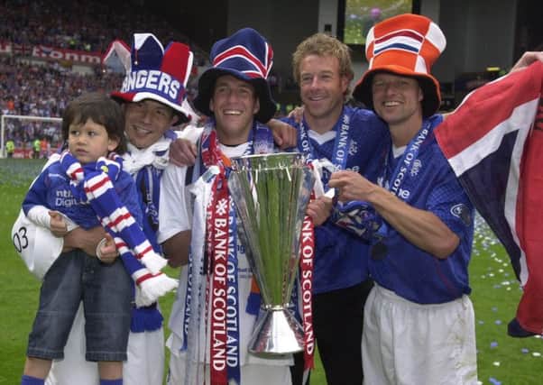 Arthur Numan along with (left to right) Michael Mols, Fernando Rickson and Bert Konterman and Arthur Numan after Rangers claimed the 2002/03 Scottish Premier League title. Picture: PA