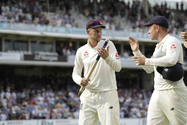 England captain Joe Root, left, is congratulated by wicketkeeper Johnny Bairstow following victory over South Africa. Picture: AP.