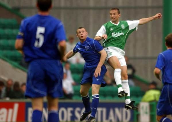 Wayne Rooney challenges Hibs' Gary Smith during a pre-season friendly at Easter Road. Picture: Sean Bell.