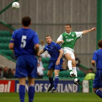Wayne Rooney challenges Hibs' Gary Smith during a pre-season friendly at Easter Road. Picture: Sean Bell.