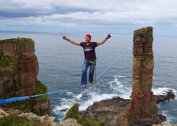 A German adventurer has become the first person to walk to and from the summit of the Old Man of Hoy on a high wire. Alexander Schulz completed the walk 137m above the sea on a line 180m long.  Picture: Dan Hunt