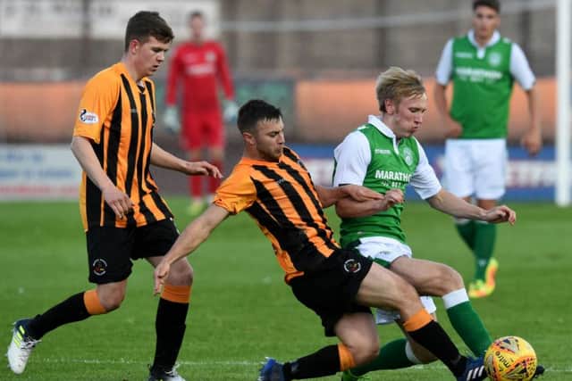 Berwick Rangers Chris McDonald tackles Fraser Murray of Hibs during the Edinburgh clubs 2-0 victory. Picture: SNS.