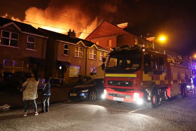 Firefighters at the scene as a bonfire at Ravenscroft Avenue in Belfast. Picture: PA Wire